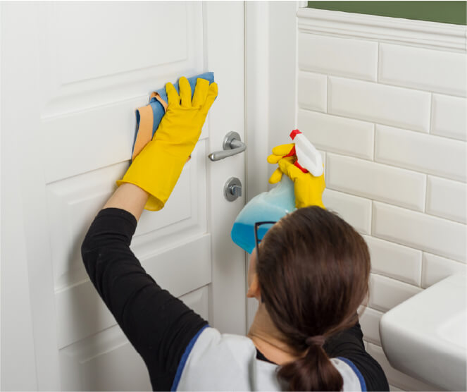 Cleaner wiping bathroom door